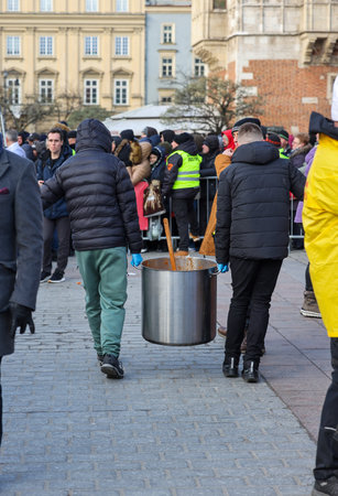 Krakow, Poland - Dec 17, 2023: Christmas Eve for the poor and homeless on the Main Square in Cracow. The group Kosciuszko prepares the greatest eve in the open air in Krakowのeditorial素材