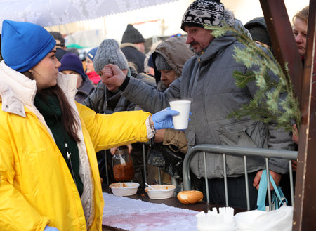 Krakow, Poland - Dec 17, 2023: Christmas Eve for the poor and homeless on the Main Square in Cracow. The group Kosciuszko prepares the greatest eve in the open air in Krakowのeditorial素材