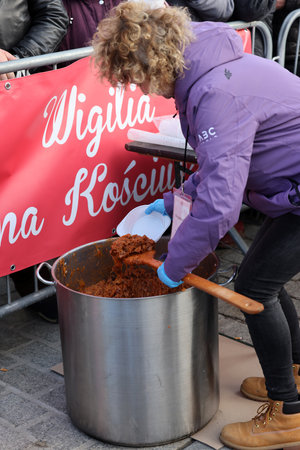 Krakow, Poland - Dec 17, 2023: Christmas Eve for the poor and homeless on the Main Square in Cracow. The group Kosciuszko prepares the greatest eve in the open air in Krakowのeditorial素材