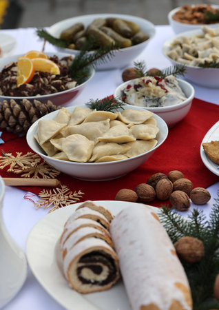 Christmas food on the table decorating with a white tableclothの写真素材