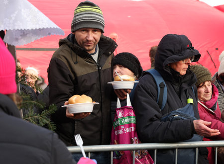 Krakow, Poland - Dec 17, 2023: Christmas Eve for the poor and homeless on the Main Square in Cracow. The group Kosciuszko prepares the greatest eve in the open air in Krakowのeditorial素材