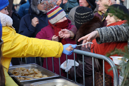 Krakow, Poland - Dec 17, 2023: Christmas Eve for the poor and homeless on the Main Square in Cracow. The group Kosciuszko prepares the greatest eve in the open air in Krakowのeditorial素材