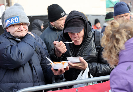 Krakow, Poland - Dec 17, 2023: Christmas Eve for the poor and homeless on the Main Square in Cracow. The group Kosciuszko prepares the greatest eve in the open air in Krakowのeditorial素材