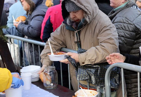 Krakow, Poland - Dec 17, 2023: Christmas Eve for the poor and homeless on the Main Square in Cracow. The group Kosciuszko prepares the greatest eve in the open air in Krakowのeditorial素材
