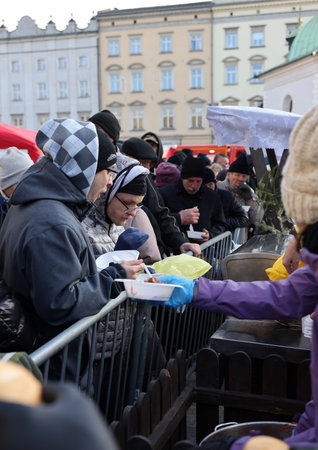 Krakow, Poland - Dec 17, 2023: Christmas Eve for the poor and homeless on the Main Square in Cracow....