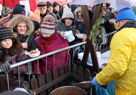 Krakow, Poland - Dec 17, 2023: Christmas Eve for the poor and homeless on the Main Square in Cracow. The group Kosciuszko prepares the greatest eve in the open air in Krakowのeditorial素材