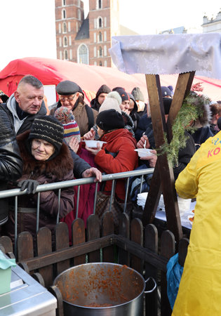 Krakow, Poland - Dec 17, 2023: Christmas Eve for the poor and homeless on the Main Square in Cracow. The group Kosciuszko prepares the greatest eve in the open air in Krakowのeditorial素材