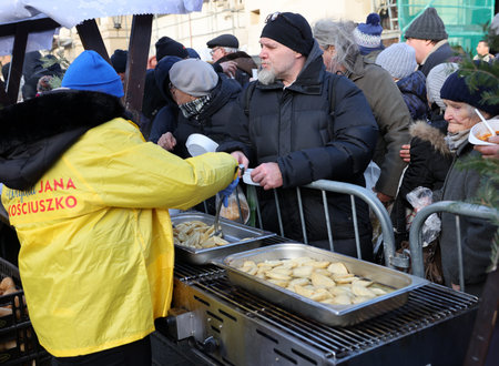 Krakow, Poland - Dec 17, 2023: Christmas Eve for the poor and homeless on the Main Square in Cracow. The group Kosciuszko prepares the greatest eve in the open air in Krakowのeditorial素材