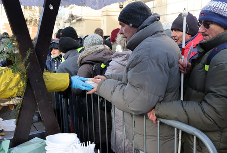 Krakow, Poland - Dec 17, 2023: Christmas Eve for the poor and homeless on the Main Square in Cracow. The group Kosciuszko prepares the greatest eve in the open air in Krakowのeditorial素材