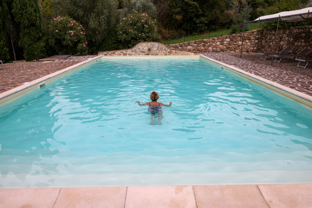 Woman swimming in pool during vacation in Montemassi. Italyの写真素材