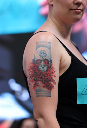 Krakow, Poland - June 12, 2022: Unidentified participant during the contest for the best tattoo at the 15th Tattoofest Convention in Cracow. One of the most prestigious tattoo festivals.のeditorial素材