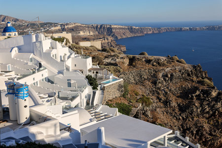 Imerovigli, Santorini, Greece - June 29, 2021: Whitewashed houses with terraces and pools and a beautiful view in Imerovigli on Santorini island, Greeceのeditorial素材