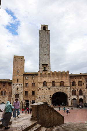 San Gimignano, Italy - Sept 17, 2022: Palazzo Vecchio del Podesta and the Rognosa Tower, also known as the Clock Tower or Podesta Tower in Piazza del Duomo in San Gimignano.のeditorial素材