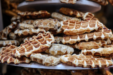 a stack of waffles sprinkled with powdered sugarの写真素材