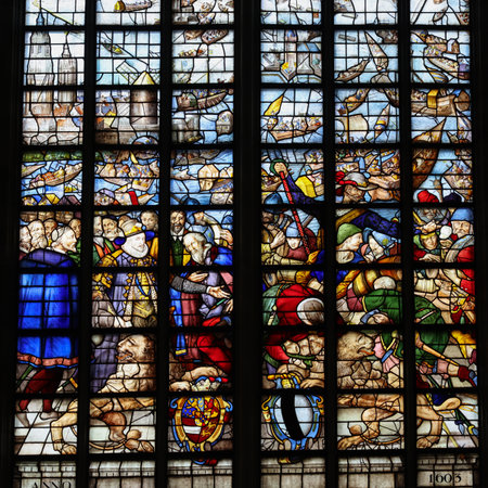 Gouda, the Nehterlands - April 20, 2023: The Stained glass window Siege of Leiden ends by Isaac van Swanenburg in the Sint Janskerk in Gouda, the Nehterlandsのeditorial素材