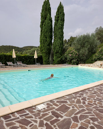Woman swimming in pool during vacation in Montemassi. Italyの写真素材