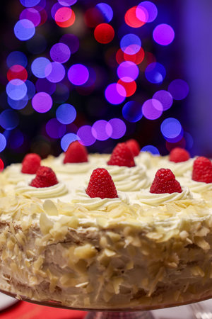 A delicious and tempting cake decorated with almonds and raspberriesの写真素材