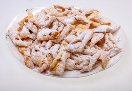 Angel wings (Faworki), cakes. Sweet pastry deep fried and sprinkled with powdered sugarの写真素材