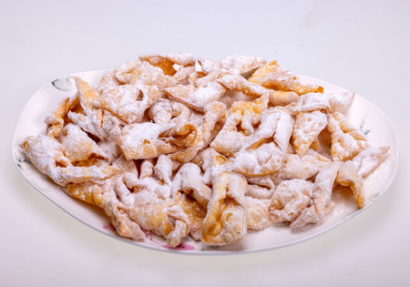 Angel wings (Faworki), cakes. Sweet pastry deep fried and sprinkled with powdered sugarの写真素材