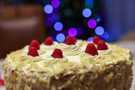 A delicious and tempting cake decorated with almonds and raspberriesの写真素材