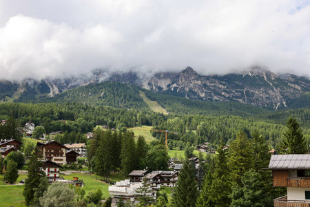 View from Cortina d Ampezzo of the Dolomites shrouded in clouds. Italyの写真素材