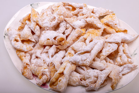 Angel wings (Faworki), cakes. Sweet pastry deep fried and sprinkled with powdered sugarの写真素材