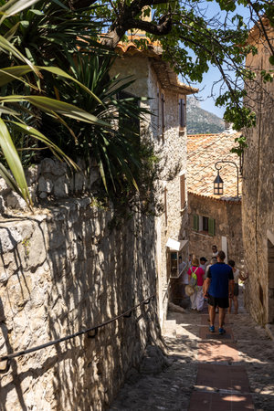 Eze, France - Juni 18, 2025: Tourists walking through the narrow streets in Eze - the famous,...