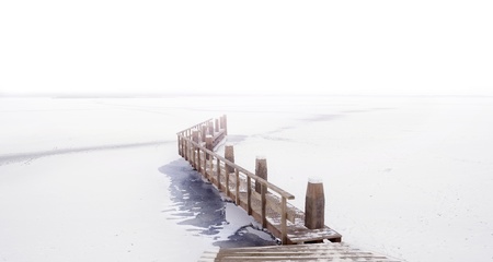 Panorama shot of a pier at a frozen lake 