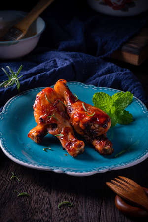 Orleans roasted chicken drumsticks in a dark atmosphereの写真素材