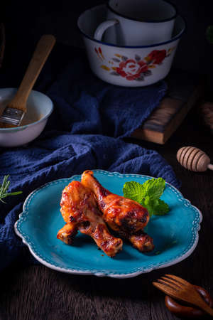 Orleans roasted chicken drumsticks in a dark atmosphereの写真素材