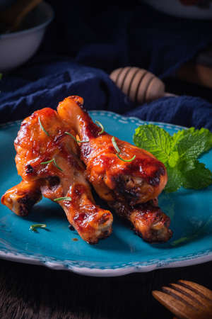 Orleans roasted chicken drumsticks in a dark atmosphereの写真素材