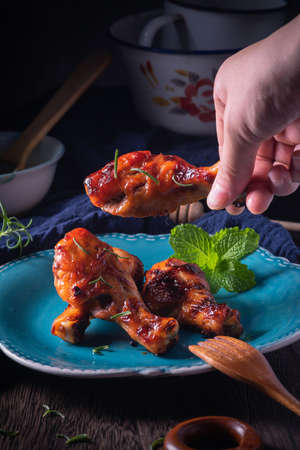 Orleans roasted chicken drumsticks in a dark atmosphereの写真素材