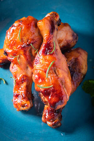 Orleans roasted chicken drumsticks in a dark atmosphereの写真素材