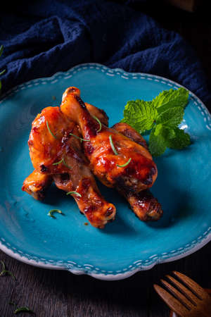 Orleans roasted chicken drumsticks in a dark atmosphereの写真素材