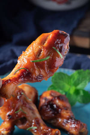 Orleans roasted chicken drumsticks in a dark atmosphereの写真素材