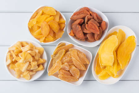 Candied dried fruit combination on white wooden boardの写真素材