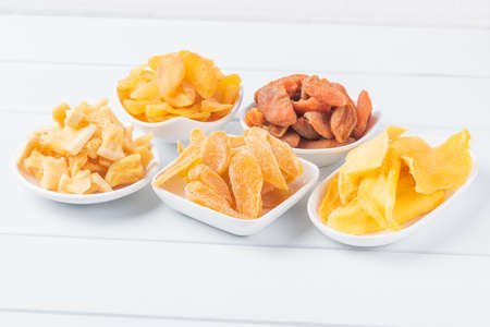 Candied dried fruit combination on white wooden boardの写真素材