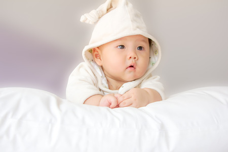 portrait of adorable baby on the bedの写真素材