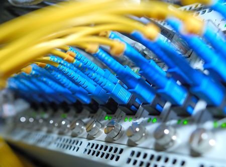 network hub and patch cables,Fiber cables connected to servers in a datacenter(See more network...