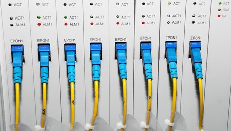 network hub and patch cables,Fiber cables connected to servers in a datacenter の写真素材
