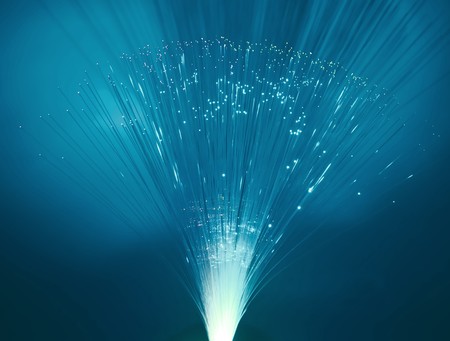 fibre optic light strands cascading down with a black background. の写真素材