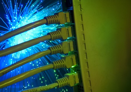 network cable and hub closeup with fiber optical background の写真素材