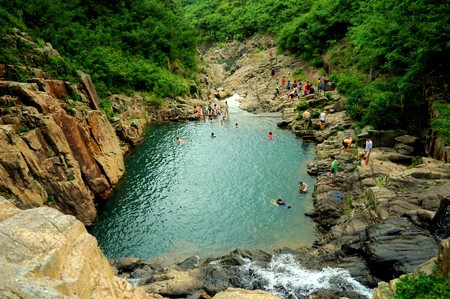 People playing beside the pondのeditorial素材