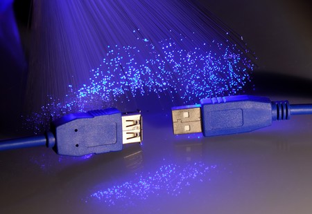 USB plugs closeup with fiber optical backgroundの写真素材
