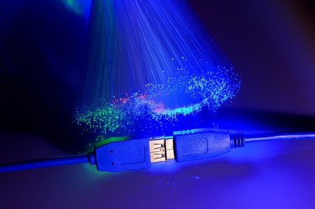 USB plugs closeup with fiber optical backgroundの写真素材