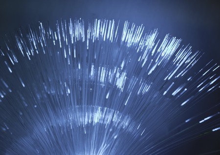 bunch of optical fibres dinamic flying from deep on technology backgroundの写真素材