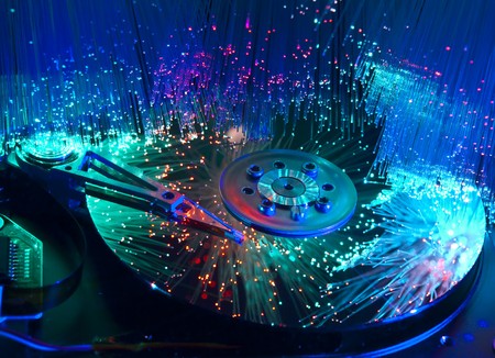 computer harddisk and heads on technology fiber optics background の写真素材