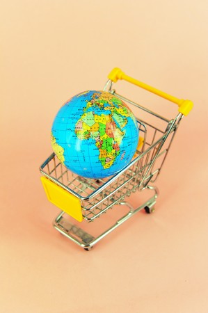 concept of shopping cart with a globe world made of glass の写真素材