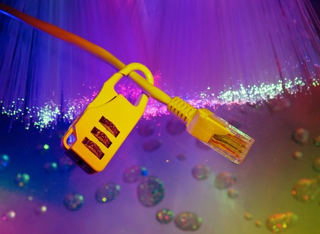 Lock and network cable with computer keyboard background の写真素材