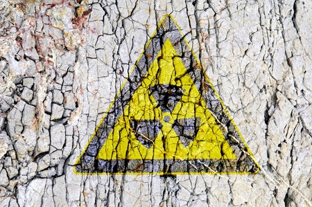 radioactivity symbol on abstract rough grunge brick wall backgroundの写真素材